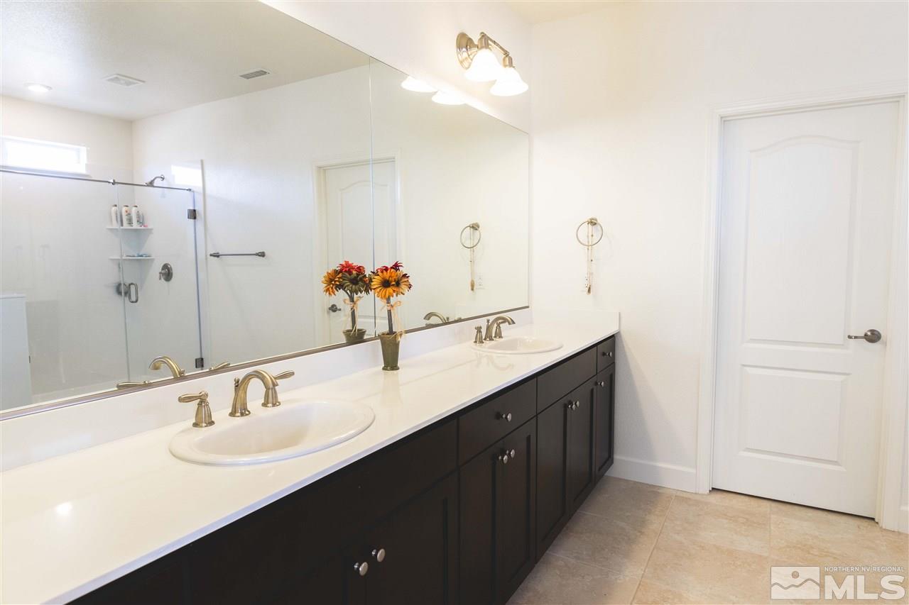 9746 Pachuca Drive Reno, NV 89521 - Photo 16 of 25 a bathroom with a double vanity sink and mirror