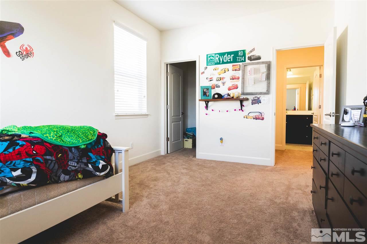 9746 Pachuca Drive Reno, NV 89521 - Photo 18 of 25 a bedroom with a bed and a refrigerator
