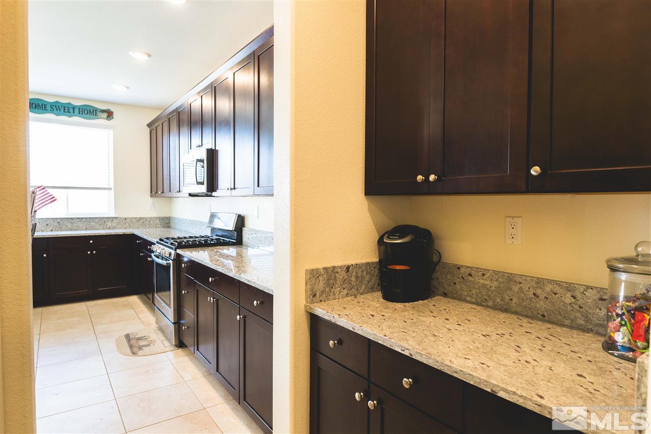 9746 Pachuca Drive Reno, NV 89521 - Photo 3 of 25 a kitchen with granite countertop cabinets and window