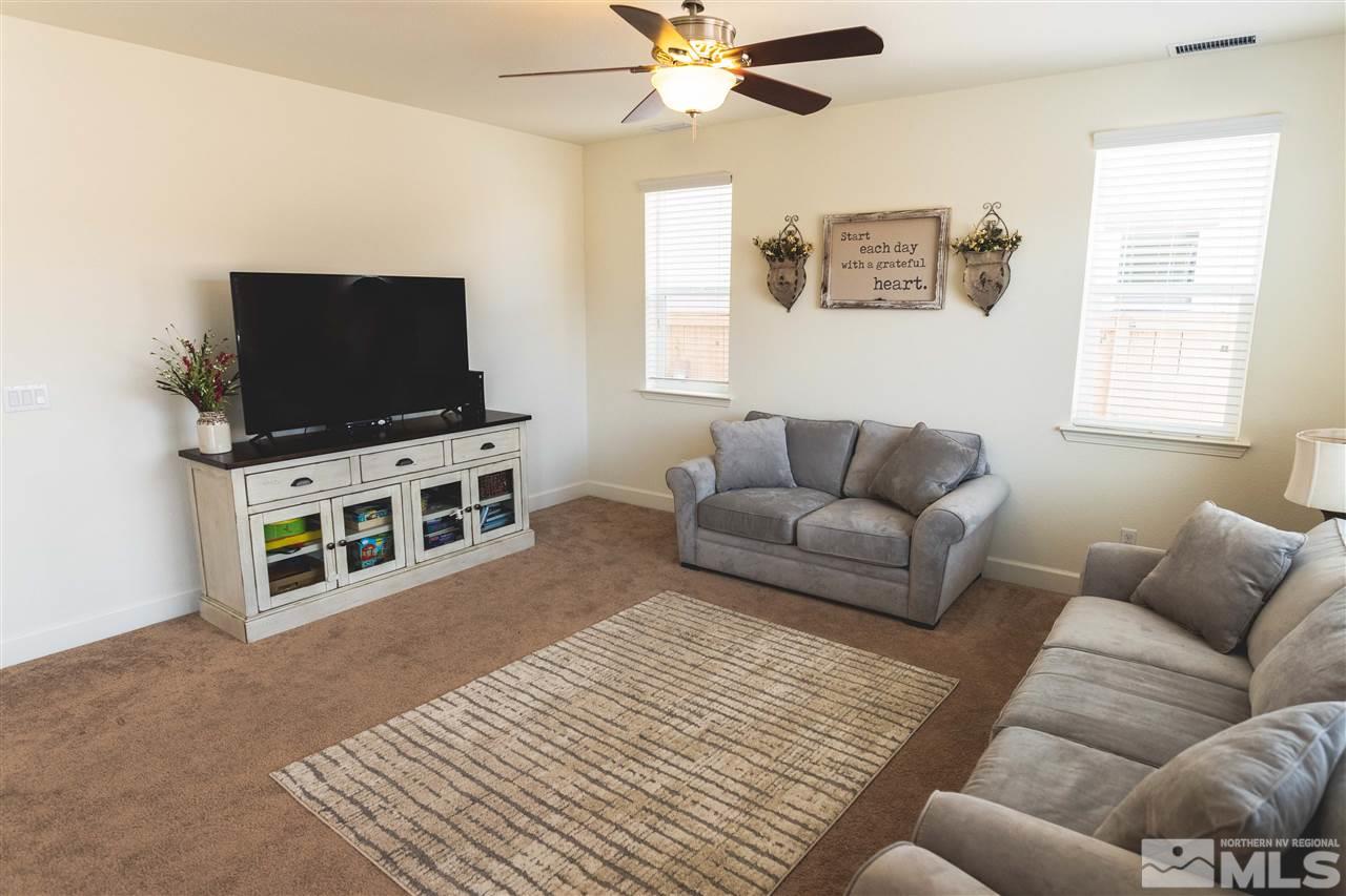 9746 Pachuca Drive Reno, NV 89521 - Photo 6 of 25 a living room with furniture and a flat screen tv