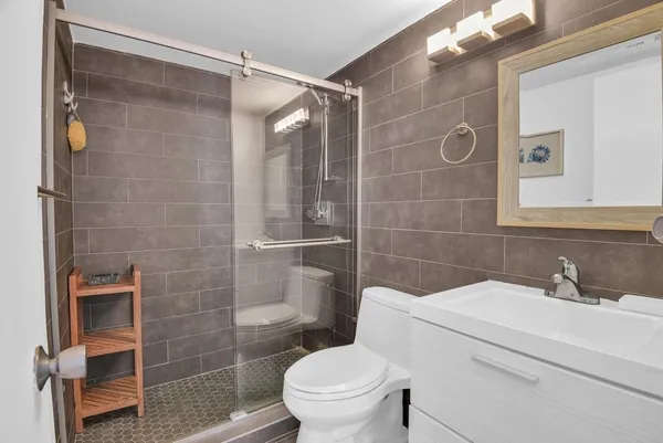 a bathroom with a sink toilet and shower