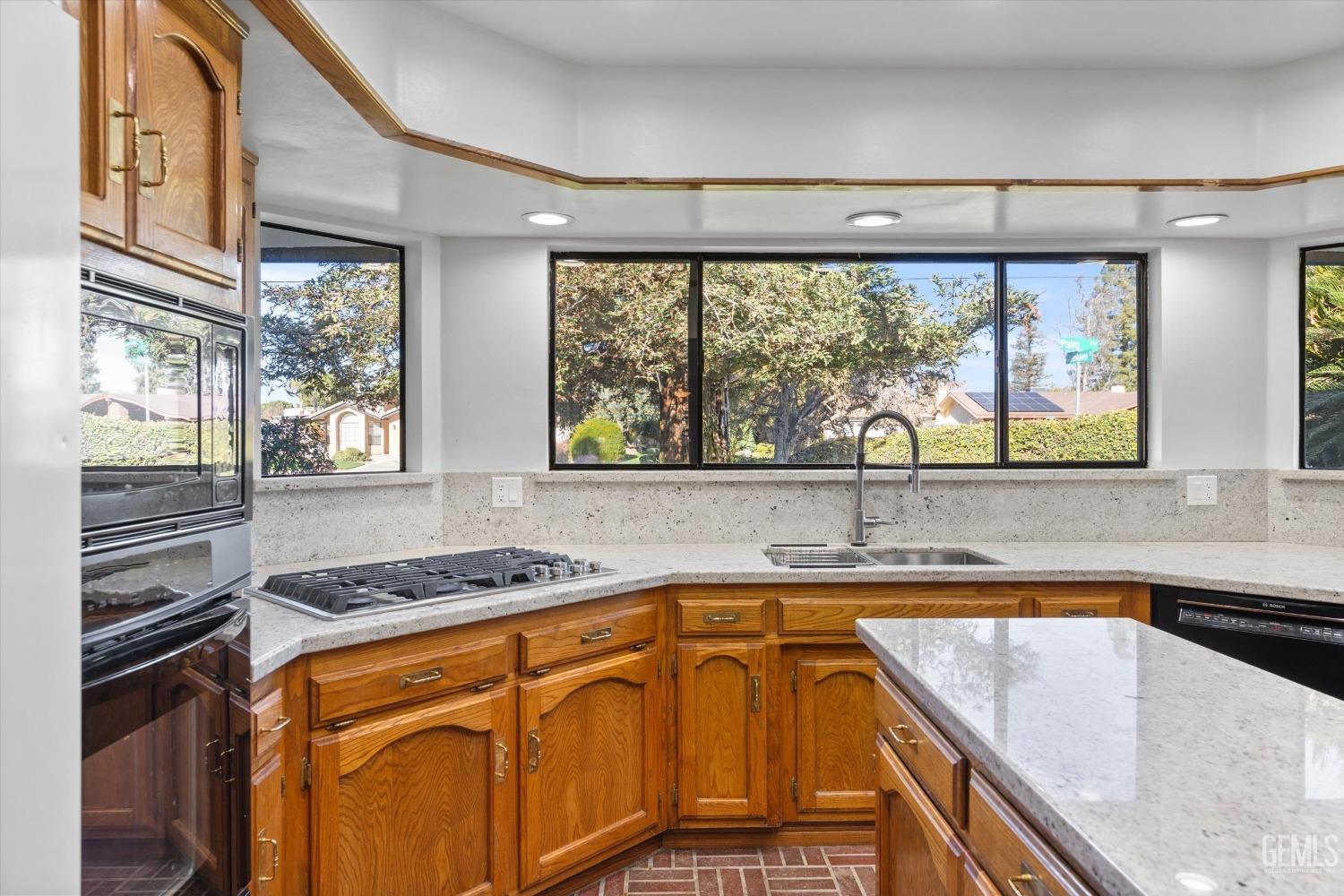 Undisclosed Address Bakersfield, CA 93312 - Photo 11 of 49 a kitchen with a sink and a stove top oven