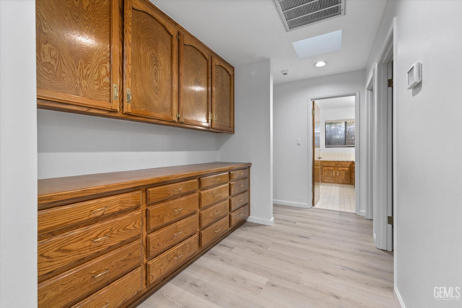 Undisclosed Address Bakersfield, CA 93312 - Photo 15 of 49 a view of kitchen with wooden floor and cabinets