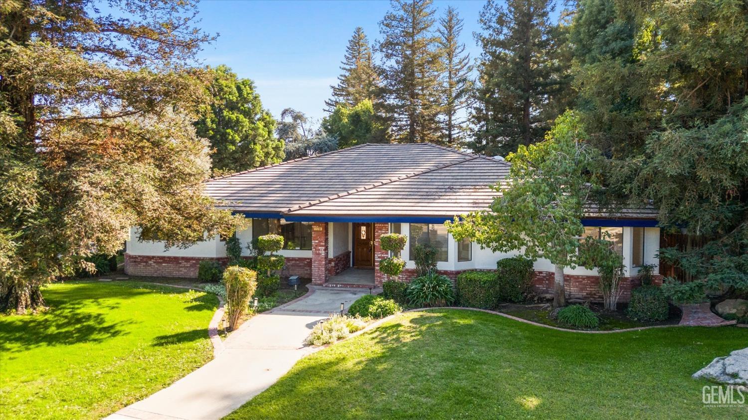 Undisclosed Address Bakersfield, CA 93312 - Photo 2 of 49 a view of a house with garden and a patio