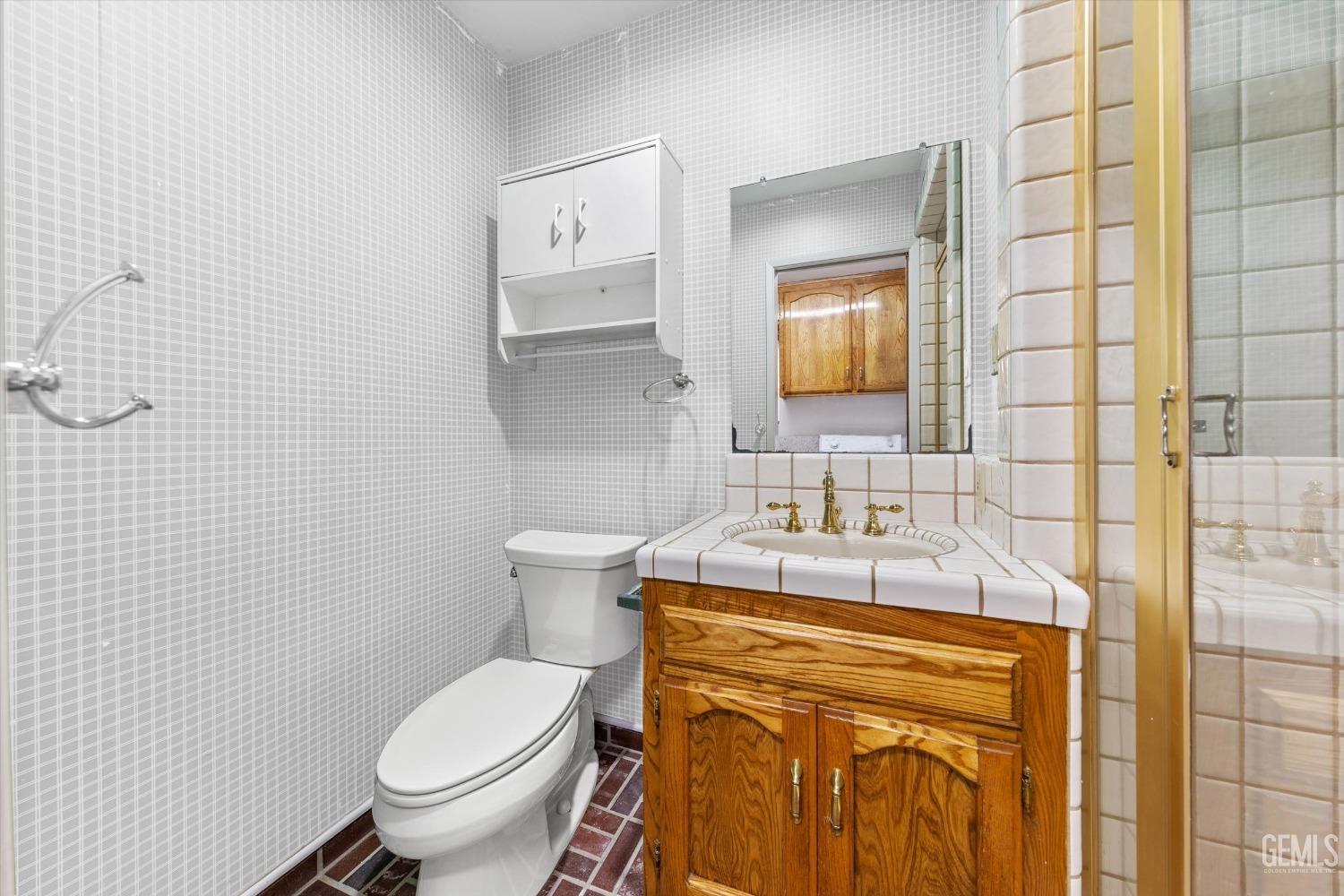 Undisclosed Address Bakersfield, CA 93312 - Photo 27 of 49 a bathroom with a granite countertop toilet sink and mirror