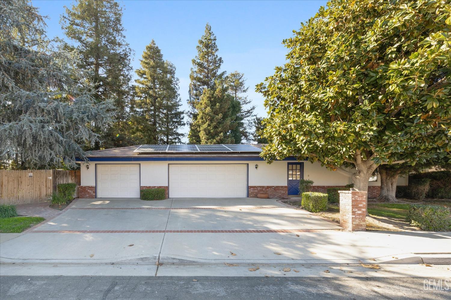 Undisclosed Address Bakersfield, CA 93312 - Photo 40 of 49 a front view of a house with a yard and garage