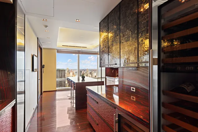 a kitchen with a large window and dining table