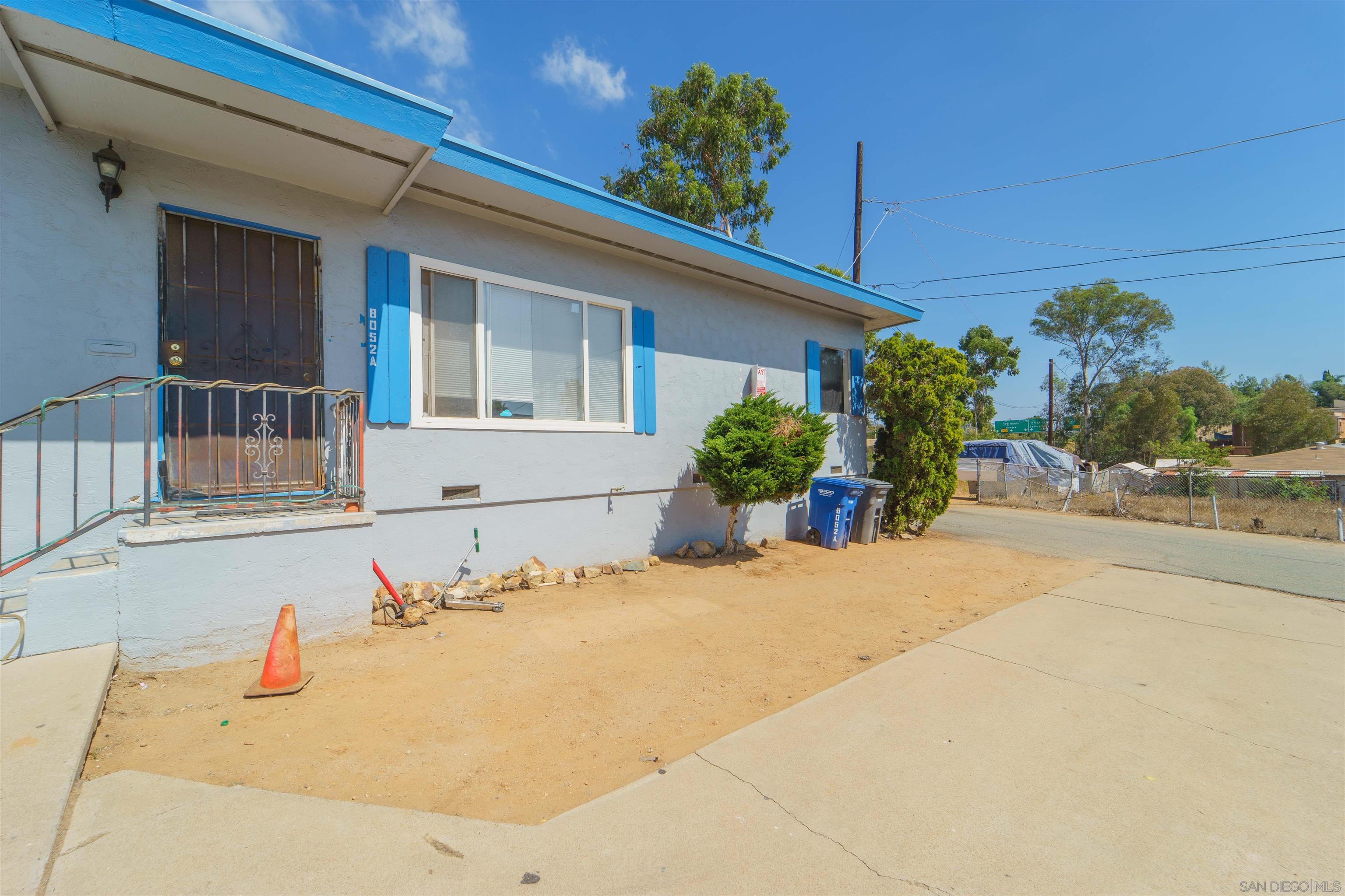 8050 Lemon Grove Way Lemon Grove, CA 91945 - Photo 12 of 19 a front view of a house with a yard