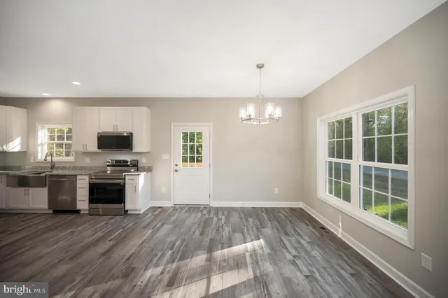 a view of a kitchen with a sink and refrigerator