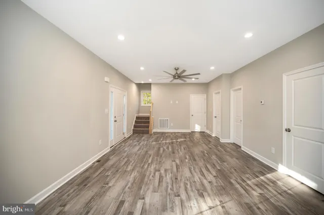 a kitchen with granite countertop a stove sink and microwave