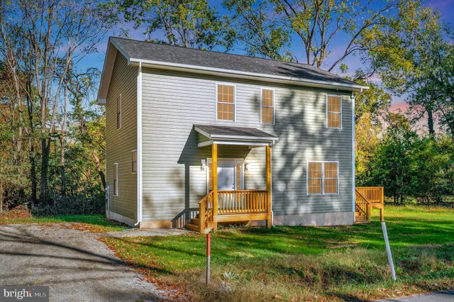 a view of front door of a house with a yard