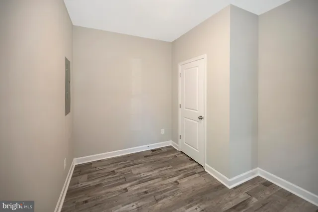 an empty room with a window and a ceiling fan