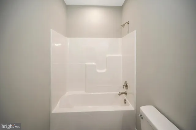 a view of a livingroom with a ceiling fan and window