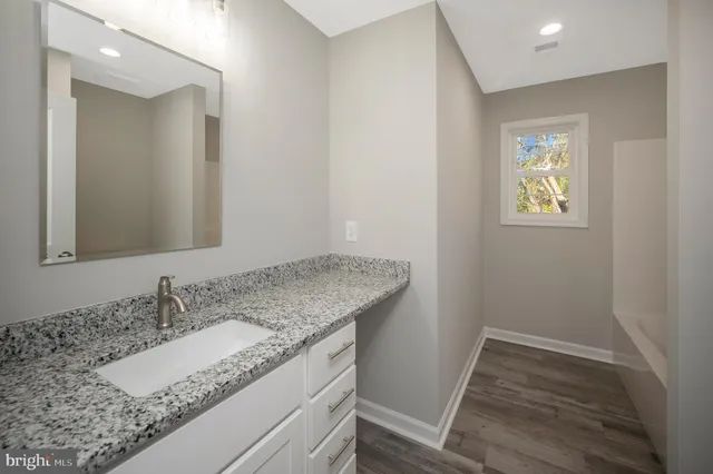 a front view of a house with a yard and potted plants