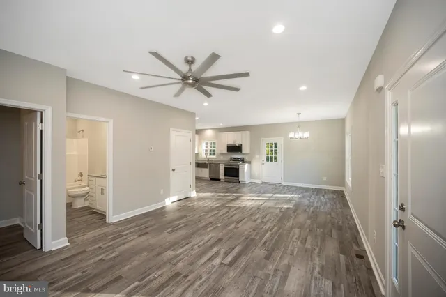 a view of an empty room with wooden floor