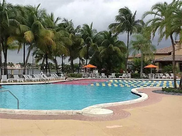 a view of swimming pool with outdoor seating and plants