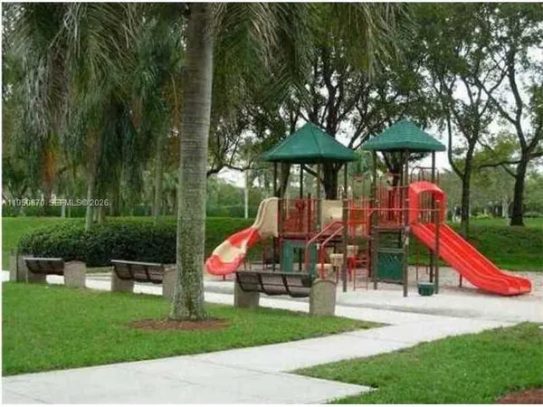 a view of park with large trees and playing table