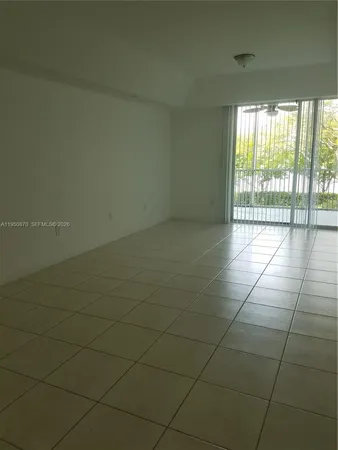 a view of a livingroom with an empty space and a window