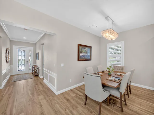 a view of a dining room with furniture window and wooden floor