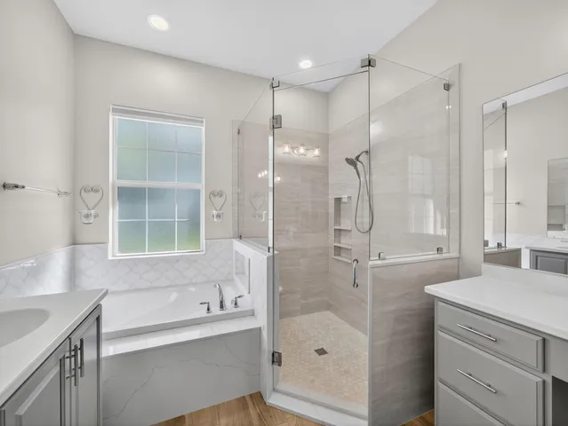 a bathroom with a shower sink and mirror