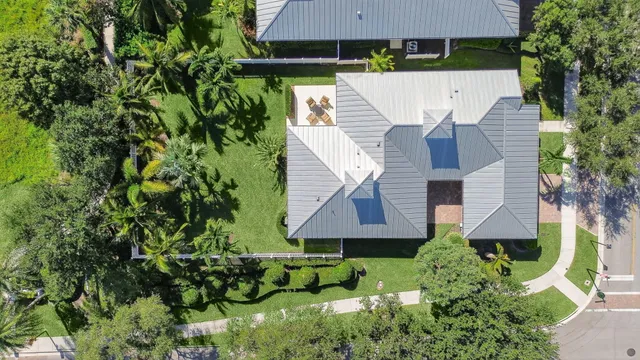 an aerial view of a house with a yard and sitting area