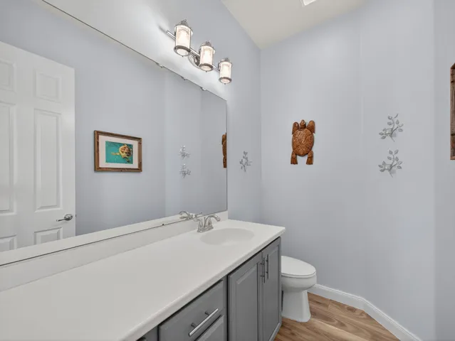 a bathroom with a sink mirror and toilet