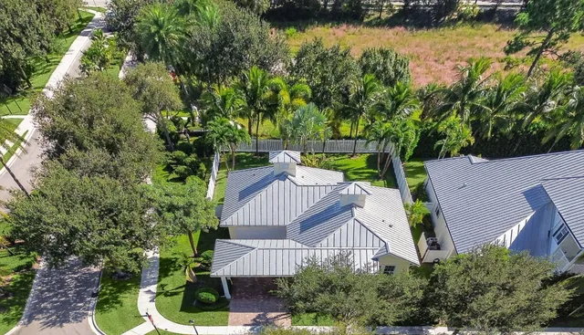 an aerial view of house with yard and swimming pool