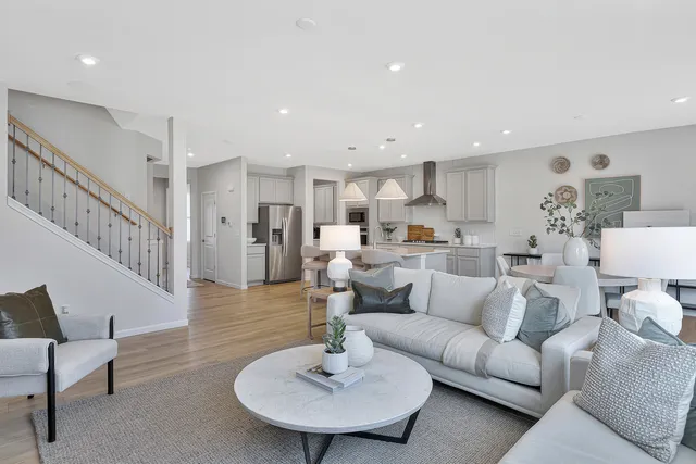 a living room with furniture and a dining table with kitchen view
