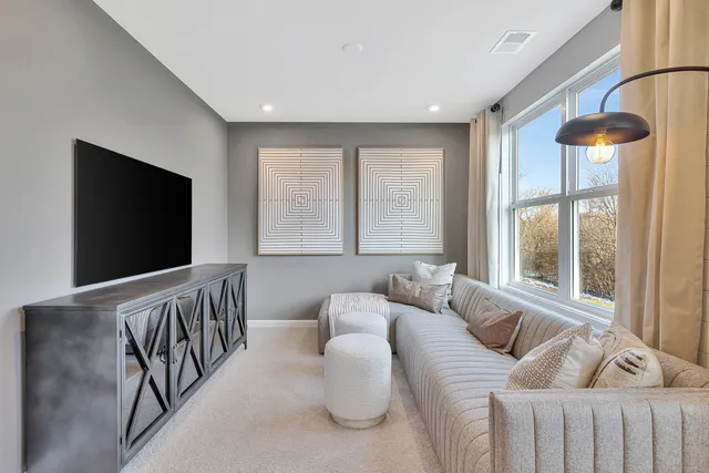 a bedroom with furniture and a flat screen tv