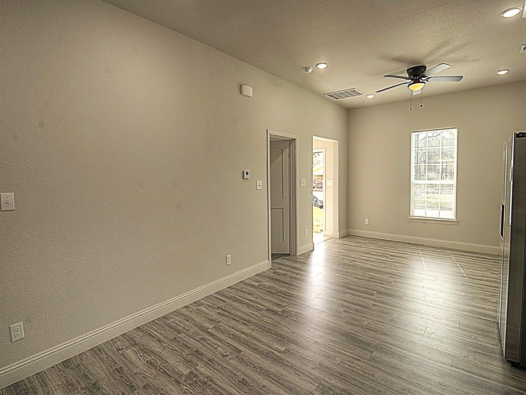 605 Olive Street Cleburne, TX 76031 - Photo 15 of 40 a view of an empty room with wooden floor and a window