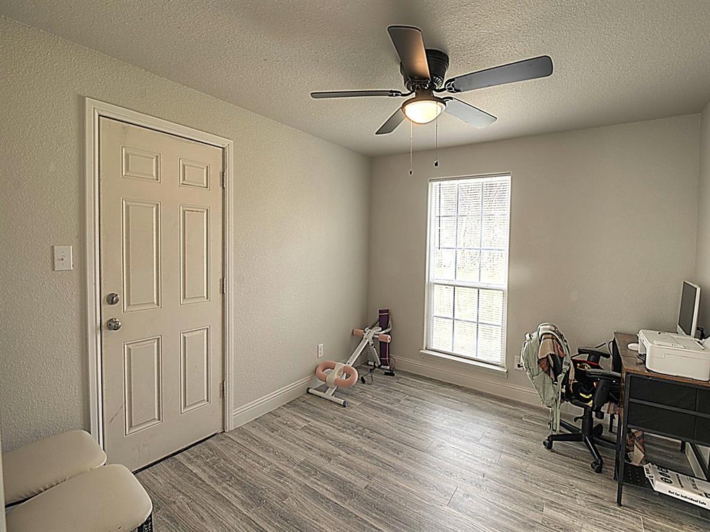 605 Olive Street Cleburne, TX 76031 - Photo 22 of 40 a work room with furniture and a window