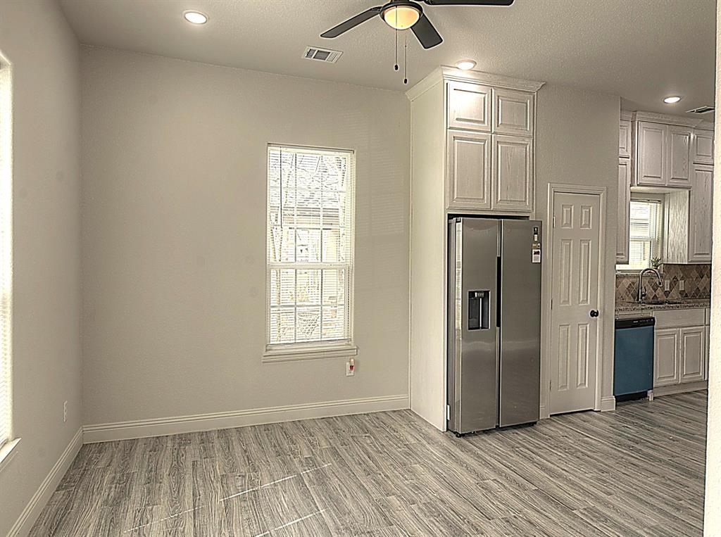 605 Olive Street Cleburne, TX 76031 - Photo 3 of 40 a view of an empty room with a window and wooden floor