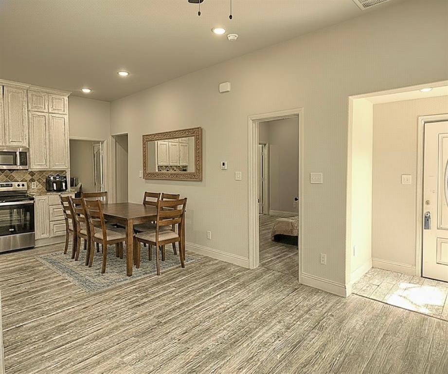605 Olive Street Cleburne, TX 76031 - Photo 36 of 40 a view of a dining room with furniture and wooden floor