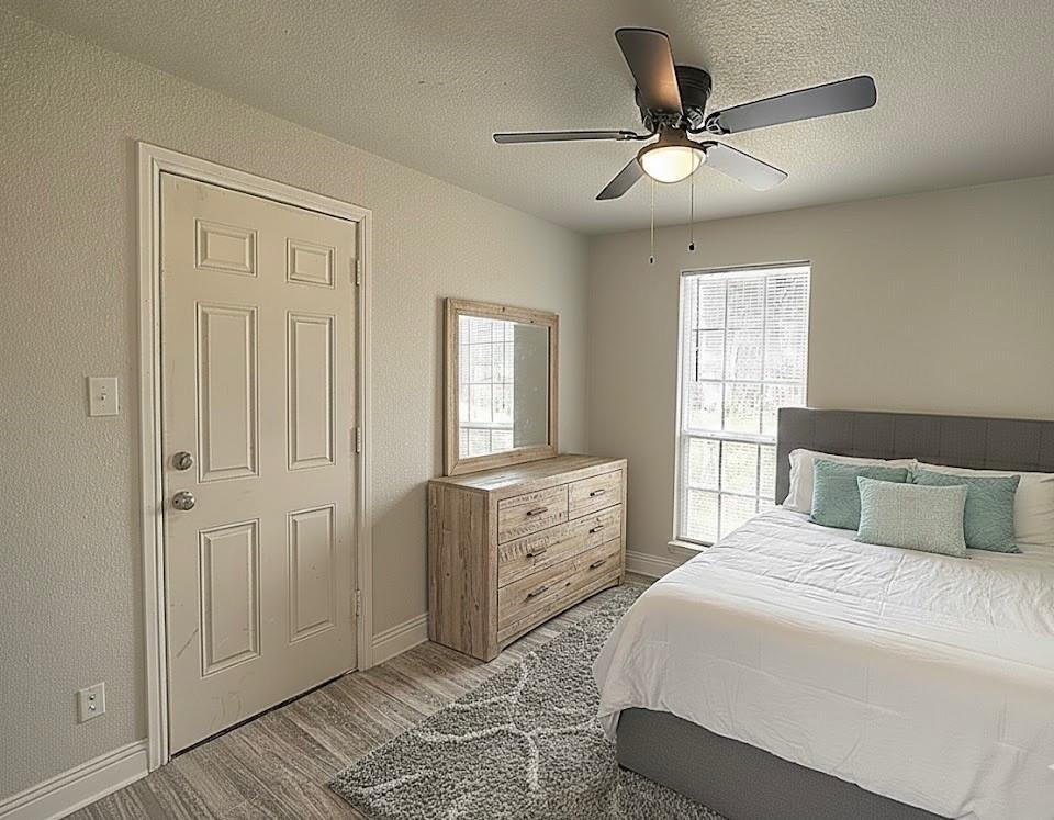 605 Olive Street Cleburne, TX 76031 - Photo 37 of 40 a bedroom with a large bed and a window