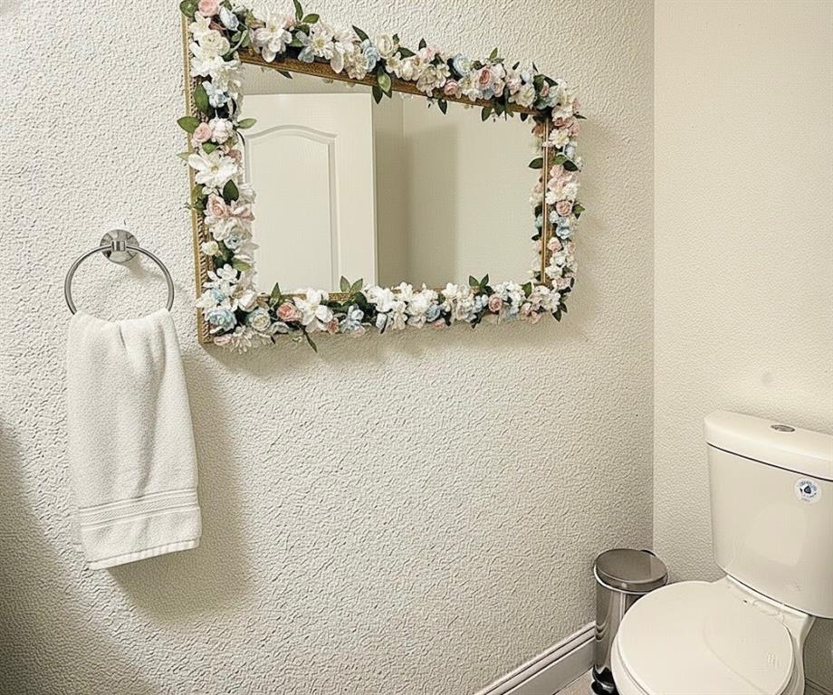 605 Olive Street Cleburne, TX 76031 - Photo 40 of 40 a bathroom with a toilet sink and mirror