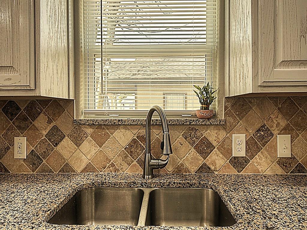 605 Olive Street Cleburne, TX 76031 - Photo 5 of 40 a kitchen with a sink and a window