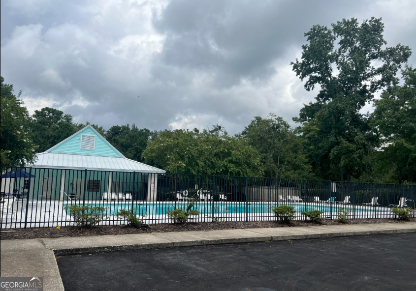 0 Secret Cove Road Woodbine, GA 31569 - Photo 11 of 12 a front view of a house with a garden and pathway