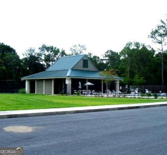 0 Secret Cove Road Woodbine, GA 31569 - Photo 9 of 12 a front view of a house with a yard and trees