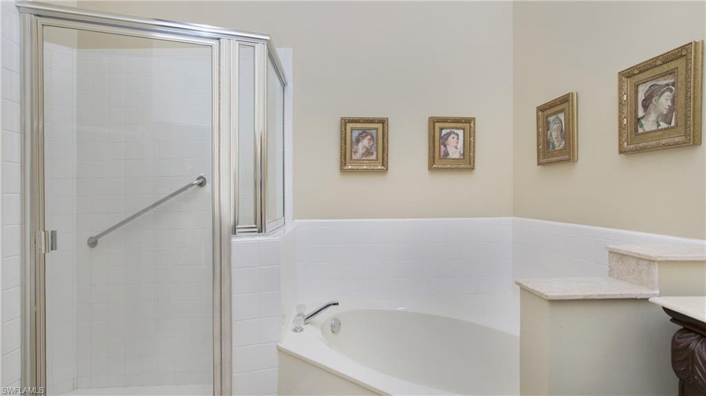 13015 Imperial Park Place, Unit 4R Naples, FL 34110 - Photo 11 of 31 Bathroom with vanity and independent shower and bath