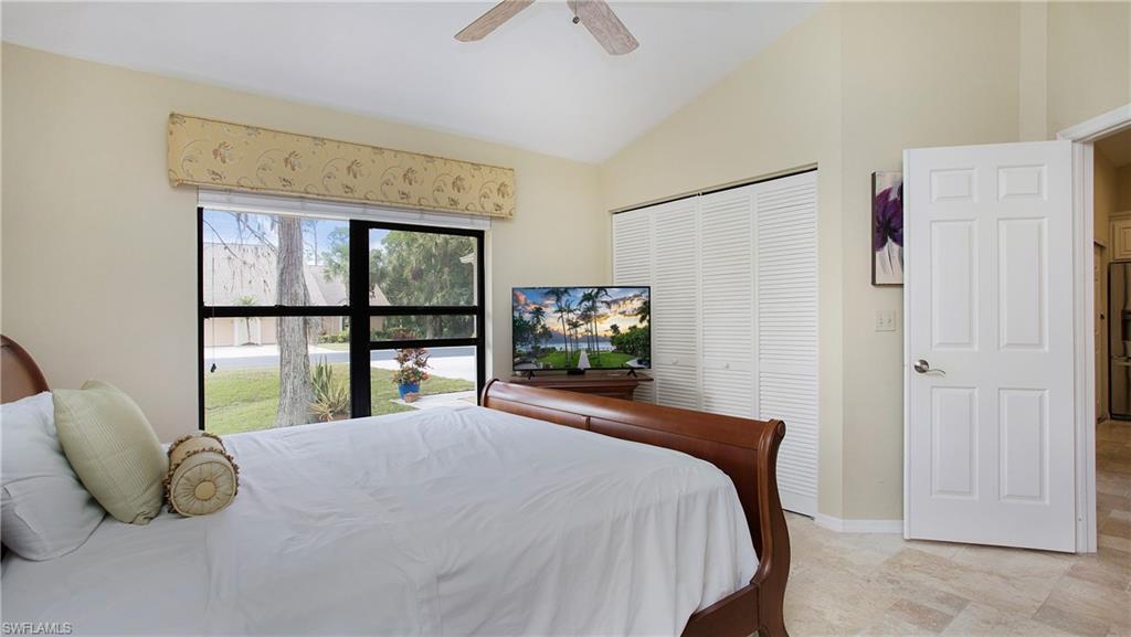 13015 Imperial Park Place, Unit 4R Naples, FL 34110 - Photo 13 of 31 Bedroom with vaulted ceiling, ceiling fan, and a closet