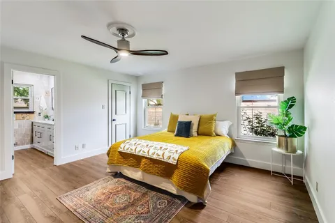 a bathroom with a granite countertop sink a toilet and shower