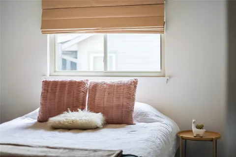 a view of a house with a yard and tree
