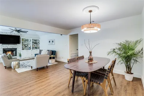 a dining room with furniture and wooden floor