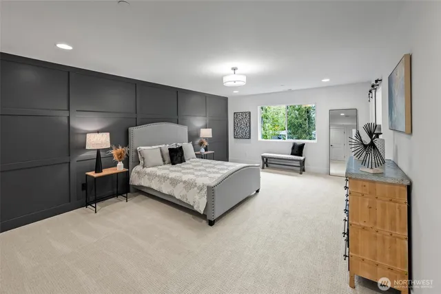 a bedroom with a large bed and a couch