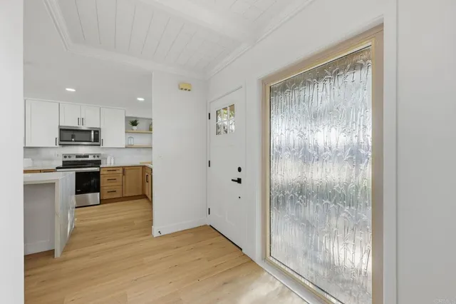 a view of kitchen with stainless steel appliances granite countertop a refrigerator and a stove top oven