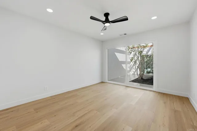 an empty room with windows and entrance