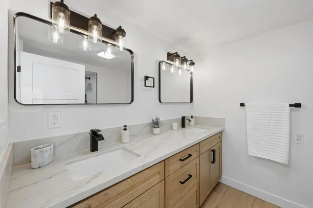 a bathroom with a sink vanity and mirror