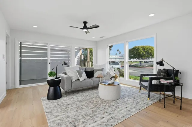 a living room with furniture and a potted plant