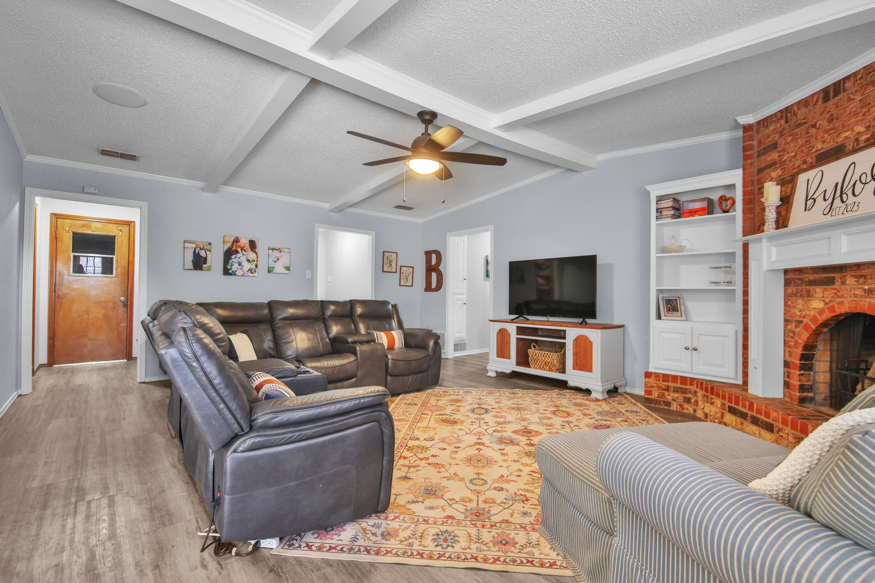 4805 73rd Street Lubbock, TX 79424 - Photo 8 of 26 a living room with furniture and a flat screen tv