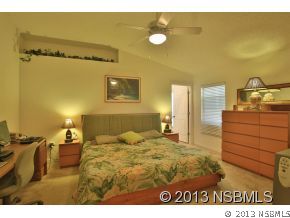 2032 Mango Tree Drive Edgewater, FL 32141 - Photo 13 of 24 a bedroom with a bed and cabinets